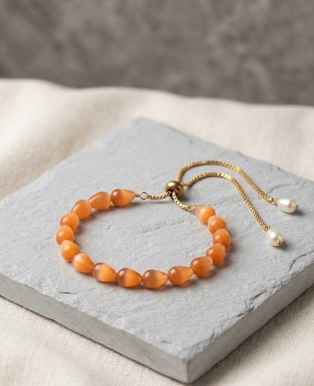 Handcrafted Adjustable Peach Glass Bead Bracelet with Pearl Accents | Taruna Creations 1 Handcrafted Adjustable Teardrop Glass Bead Bracelet